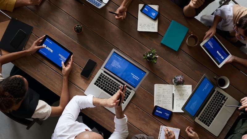 Photo of professionals with computers collaborating at a work table